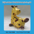 Painting ceramic giraffe piggy bank